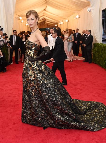 Model Karlie Kloss chose a strapless brocade gown by Oscar de la Renta.